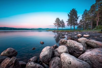 Scenic view of rocks in lake against sky