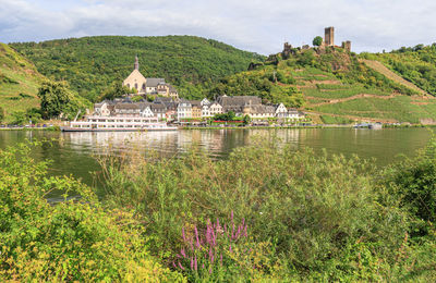 Scenic view of lake and buildings against sky