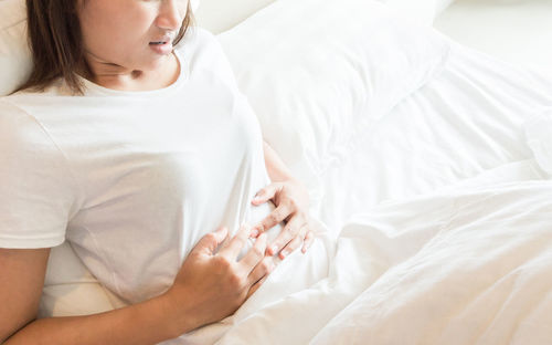 Close-up of woman lying on bed