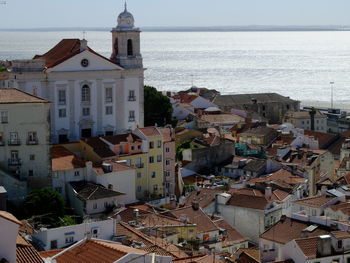 High angle view of townscape by sea