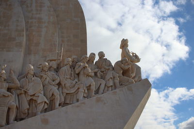 Low angle view of angel statue against sky