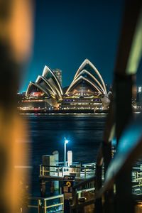 Illuminated ferris wheel in city at night