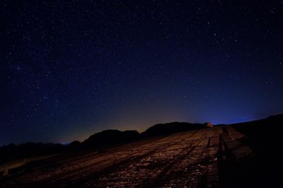 Scenic view of mountains against sky at night