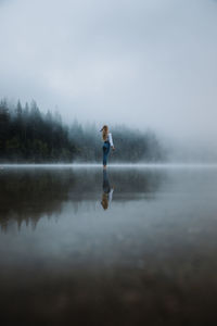 Full length of man on lake against sky