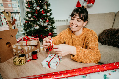 Woman with christmas tree at home