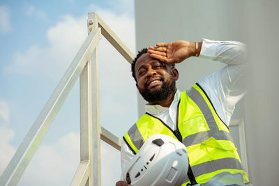 Low angle view of man standing against sky