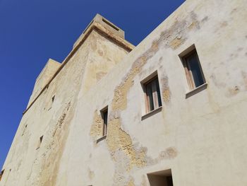 Low angle view of building against blue sky