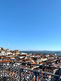 High angle shot of townscape against blue sky