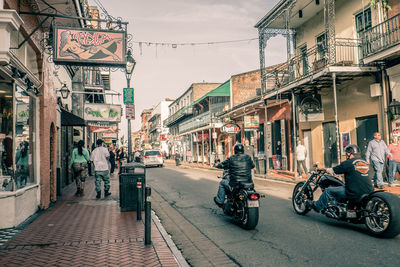 People on street in city against sky