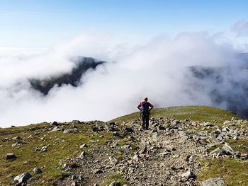 Rear view of man standing on mountain