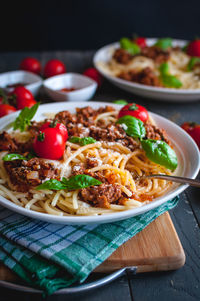 Close-up of italian spaghetti with tomato sauce, parmesan cheese and fresh basil on top