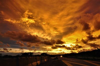 Road against dramatic sky during sunset