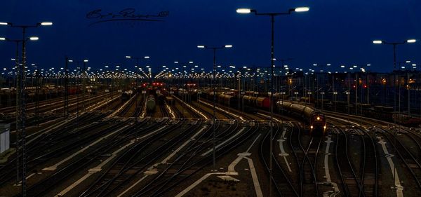 High angle view of illuminated railroad tracks at night