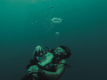 Shirtless man swimming undersea