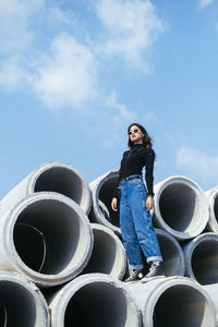 Low angle view of woman standing against sky