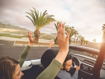 People in car on road against sky