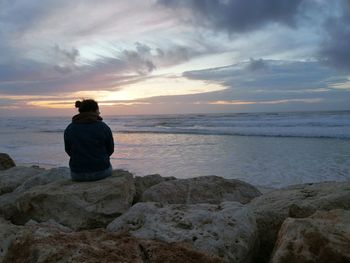 Rear view of man looking at sea shore