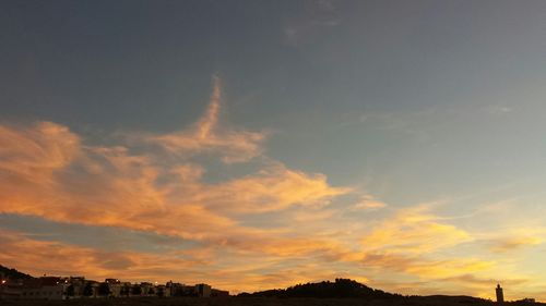 Low angle view of silhouette buildings against sky during sunset