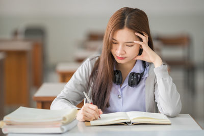 Young woman studying at classroom