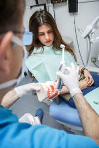 Midsection of doctor examining patient at clinic