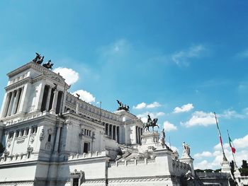 Low angle view of building against cloudy sky