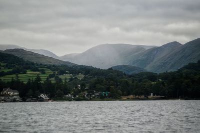 Scenic view of lake windermere and mountains against cloudy sky