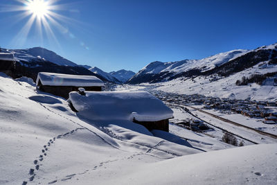 Snow covered mountains against blue sky