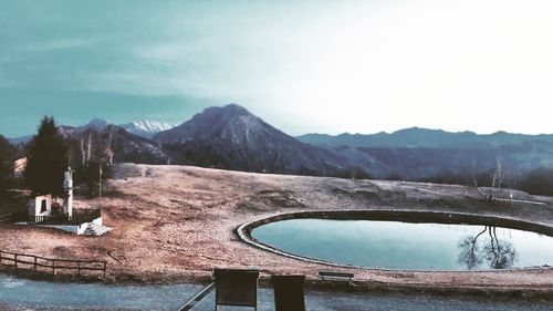 Scenic view of lake against cloudy sky during winter