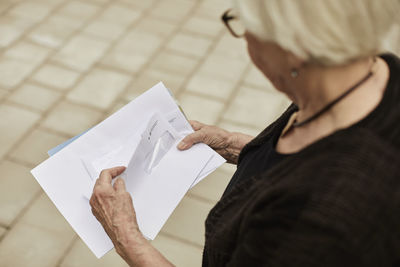 Senior woman holding letters