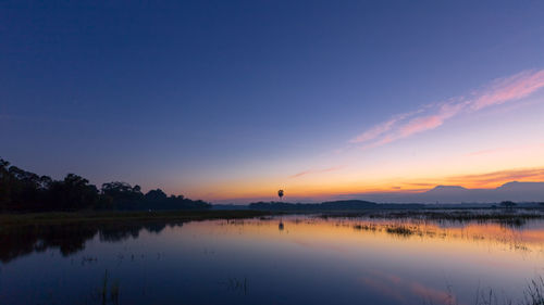 Scenic view of lake against sky during sunset