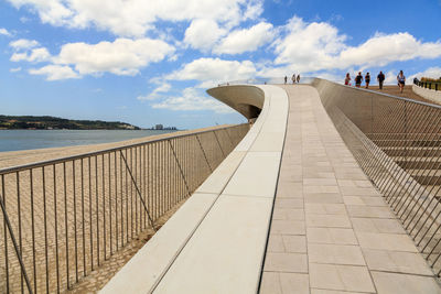 Footpath by sea against sky