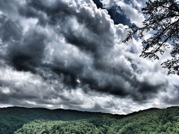 Low angle view of mountain against cloudy sky