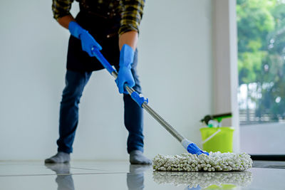 Low section of man working on floor