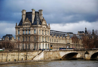 The louvre museum from seine river