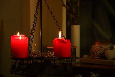 Close-up of lit candles on table