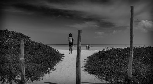 Panoramic view of people standing on footpath against sky