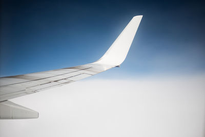 Airplane wing against clear sky