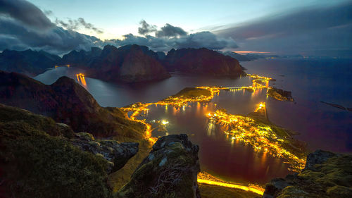 High angle view of townscape by sea against sky during sunset