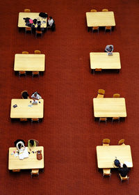 High angle view of people at desks in library