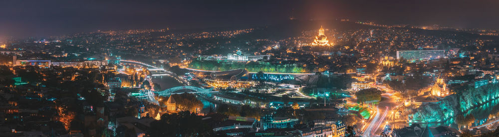 High angle view of illuminated buildings in city at night