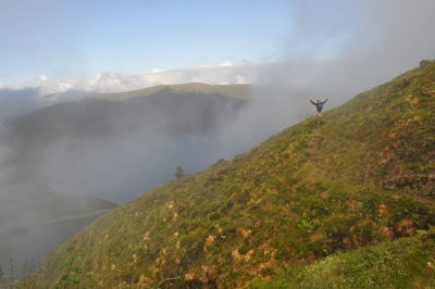 Scenic view of mountains against cloudy sky