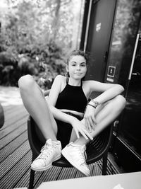 Portrait of young woman sitting on chair