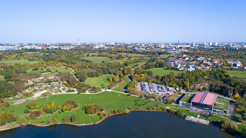 Aerial view of river amidst trees against clear sky