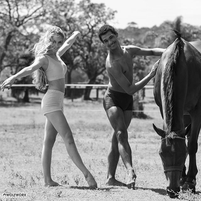 full length, lifestyles, leisure activity, horse, togetherness, casual clothing, people, focus on foreground, day, park - man made space, childhood, standing, outdoors, rear view, person, sky, playing