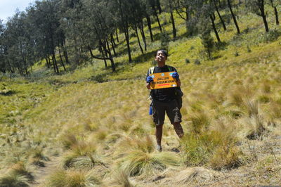 Full length of man walking in forest