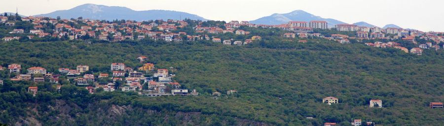 View of the croatian coast, houses by the sea, on a slope, in a wooded area, slopes by the sea