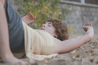 Midsection of woman resting outdoors