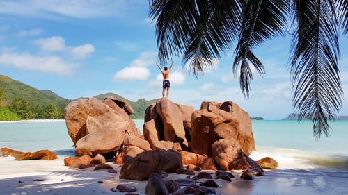 Rocks on beach against sky