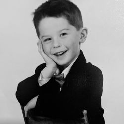 Portrait of smiling boy against gray background