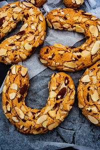 Crescent shaped baked almond cookies textured with sliced almonds